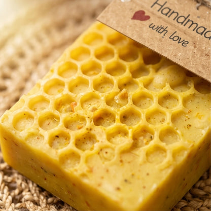 GlowHaven natural soap. Yellow honeycomb-patterned soap with a brown label on a textured surface